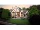 Spacious backyard featuring a pool, spa, patio, lush lawn and mature trees, ideal for outdoor living at 938 Crescent River Pass, Suwanee, GA 30024