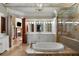 Large bathroom with a soaking tub, separate shower, and double vanity at 938 Crescent River Pass, Suwanee, GA 30024