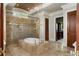 Luxurious bathroom with a stone-clad tub, glass shower, and designer fixtures at 938 Crescent River Pass, Suwanee, GA 30024