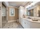 Bright bathroom features tiled floors, white cabinets, a large mirror, and a glass shower at 938 Crescent River Pass, Suwanee, GA 30024