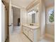 Bright bathroom with a single sink vanity, white cabinets, and large mirror at 938 Crescent River Pass, Suwanee, GA 30024