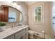 Elegant bathroom with a marble countertop vanity and a decorative mirror with a tiled floor at 938 Crescent River Pass, Suwanee, GA 30024