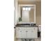 Bright bathroom features a granite countertop, large vanity, decorative rug, and large framed mirror at 938 Crescent River Pass, Suwanee, GA 30024