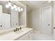 Bathroom with natural lighting, double sinks, vanity, and white cabinets at 938 Crescent River Pass, Suwanee, GA 30024