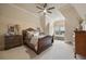 Cozy bedroom with a ceiling fan, complemented by natural light streaming through the window at 938 Crescent River Pass, Suwanee, GA 30024