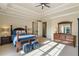 Comfortable bedroom with a large window offering natural light, ceiling fan and crown molding at 938 Crescent River Pass, Suwanee, GA 30024