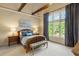 Charming bedroom with vaulted ceilings, wooden beams, and a large window at 938 Crescent River Pass, Suwanee, GA 30024