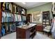 Custom walk-in closet with ample storage and a central island at 938 Crescent River Pass, Suwanee, GA 30024