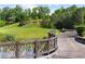 Scenic wooden bridge walkway beside a lake and golf course, enhancing the community's natural beauty at 938 Crescent River Pass, Suwanee, GA 30024