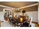 Formal dining room with an exquisite chandelier and ample seating, perfect for hosting gatherings at 938 Crescent River Pass, Suwanee, GA 30024