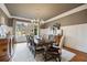 Formal dining room featuring crown molding, wainscoting, a large table, and a window with a view of the yard at 938 Crescent River Pass, Suwanee, GA 30024