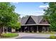 Large property featuring mature trees, well manicured landscaping, and a charming front entrance at 938 Crescent River Pass, Suwanee, GA 30024