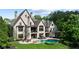 Backyard with pool, spa, stone patio with lounge chairs and firepit viewed from the home's upper deck at 938 Crescent River Pass, Suwanee, GA 30024