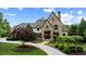 Beautiful stone home featuring arched entry, custom driveway and manicured landscaping at 938 Crescent River Pass, Suwanee, GA 30024