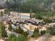 Exterior aerial view of community clubhouse with golf course and pond located within a private gated neighborhood at 938 Crescent River Pass, Suwanee, GA 30024