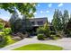 Beautiful home with a well-manicured lawn, stone accents, and a circular driveway at 938 Crescent River Pass, Suwanee, GA 30024