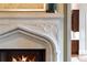 Close-up on the detailed stone fireplace with burning fire at 938 Crescent River Pass, Suwanee, GA 30024