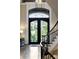Grand foyer with wrought iron staircase, arched transom and double doors at 938 Crescent River Pass, Suwanee, GA 30024