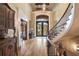 Grand foyer featuring a curved staircase, hardwood floors, and an ornate front door at 938 Crescent River Pass, Suwanee, GA 30024