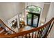 Overhead view of grand foyer with wrought iron staircase, arched transom and double doors at 938 Crescent River Pass, Suwanee, GA 30024