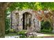 Charming stone home with arched front entrance, detailed stonework, and manicured landscaping at 938 Crescent River Pass, Suwanee, GA 30024