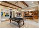 The game room features a billiard table, a bar with seating, and handsome built in cabinetry at 938 Crescent River Pass, Suwanee, GA 30024