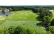 Aerial view of a pristine golf course featuring lush green fairways and a serene lake at 938 Crescent River Pass, Suwanee, GA 30024