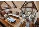 Open-concept living space with hardwood floors, exposed beams, fireplace, and lots of natural light at 938 Crescent River Pass, Suwanee, GA 30024