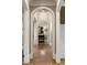 Arched hallway with gleaming hardwood floors, showcasing architectural details at 938 Crescent River Pass, Suwanee, GA 30024