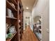 Hallway featuring a custom bookcase and an arched doorway at 938 Crescent River Pass, Suwanee, GA 30024