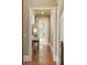 Hallway view showing hardwood floors and view to other rooms at 938 Crescent River Pass, Suwanee, GA 30024