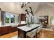Large kitchen island with seating, dark wood cabinets, and hardwood floors at 938 Crescent River Pass, Suwanee, GA 30024