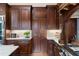 The kitchen features dark wood cabinets and white countertops with tile backsplash at 938 Crescent River Pass, Suwanee, GA 30024