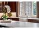 Kitchen features a marble countertop and classic finishes with an abundance of natural light at 938 Crescent River Pass, Suwanee, GA 30024