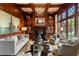 Cozy living room with custom built-ins, rich wood paneling, and a fireplace creating a warm atmosphere at 938 Crescent River Pass, Suwanee, GA 30024