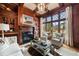 Inviting living room with wood-paneled walls, fireplace, built-ins, and comfortable seating at 938 Crescent River Pass, Suwanee, GA 30024