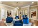 Stylish living room with cozy seating and views to staircase and bar area at 938 Crescent River Pass, Suwanee, GA 30024