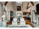 Open-concept living space with a stone fireplace, hardwood floors, and seamless flow to the dining area at 938 Crescent River Pass, Suwanee, GA 30024