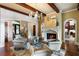 Inviting living room featuring a stone fireplace, dark wood floors and views of the foyer at 938 Crescent River Pass, Suwanee, GA 30024