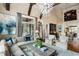 Bright and airy living room featuring high ceilings, exposed beams, designer lighting, and stylish decor at 938 Crescent River Pass, Suwanee, GA 30024