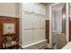 Mud room with built-in cabinets, a seating area, wood paneling, and access to the bathroom at 938 Crescent River Pass, Suwanee, GA 30024