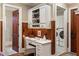 Bright office space featuring custom built-ins and adjacent laundry room at 938 Crescent River Pass, Suwanee, GA 30024