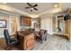 Spacious home office featuring hardwood floors, a ceiling fan, and built in shelves and cabinets for storage at 938 Crescent River Pass, Suwanee, GA 30024