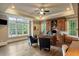 Spacious office with hardwood flooring, ceiling fan, large windows, and handsome built-in shelves at 938 Crescent River Pass, Suwanee, GA 30024