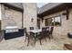 Outdoor patio dining area with stone pavers, and a built in BBQ and prep area at 938 Crescent River Pass, Suwanee, GA 30024