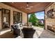 Covered brick patio with fireplace, ceiling fan and lake views at 938 Crescent River Pass, Suwanee, GA 30024