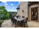 Brick patio features outdoor seating with views of lush greenery at 938 Crescent River Pass, Suwanee, GA 30024