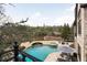 Aerial view of a backyard pool area with hot tub, lounge chairs and a view of a lake at 938 Crescent River Pass, Suwanee, GA 30024