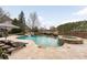 Backyard pool with waterfall feature, hot tub, mature landscaping and lake views at 938 Crescent River Pass, Suwanee, GA 30024