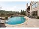 A private pool with beautiful waterfalls and lounge chairs at 938 Crescent River Pass, Suwanee, GA 30024